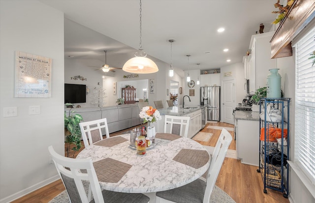 dining area featuring sink, ceiling fan, and light hardwood / wood-style floors