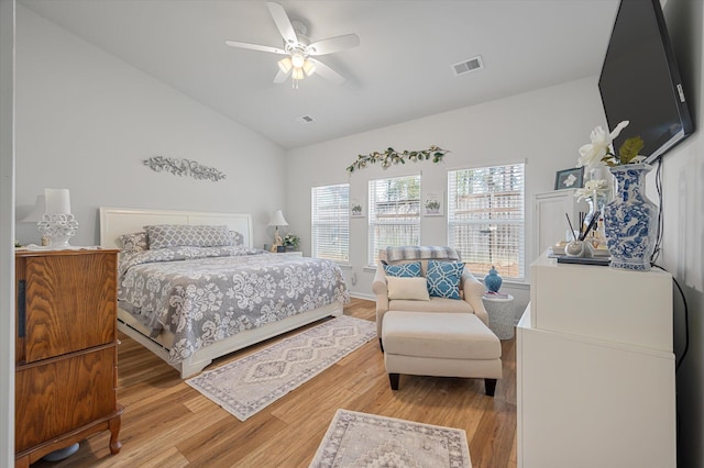 bedroom with ceiling fan, light wood-type flooring, and vaulted ceiling