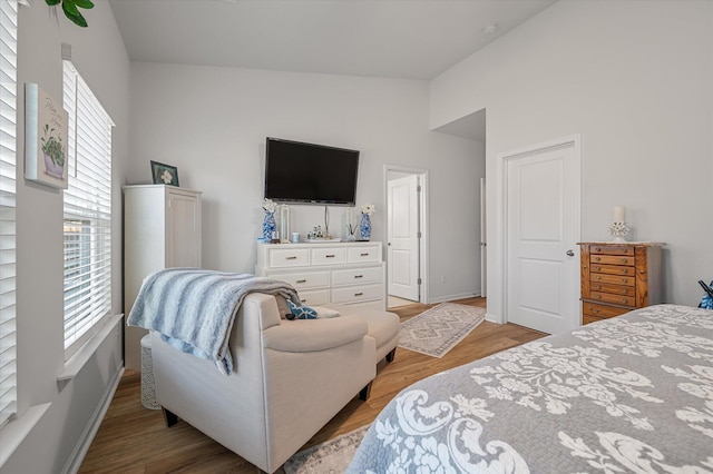 bedroom featuring wood-type flooring and vaulted ceiling