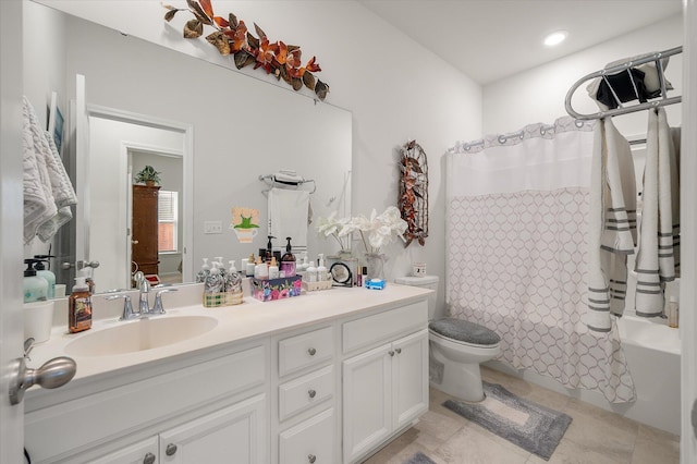 full bathroom featuring tile patterned flooring, shower / bath combo with shower curtain, vanity, and toilet