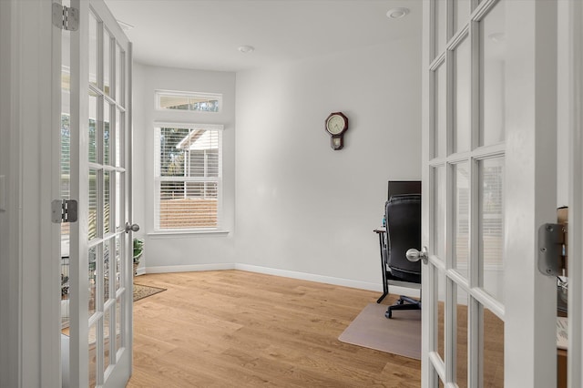 office space featuring french doors and light hardwood / wood-style flooring