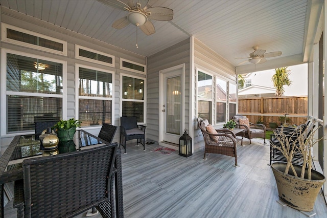 sunroom / solarium featuring ceiling fan