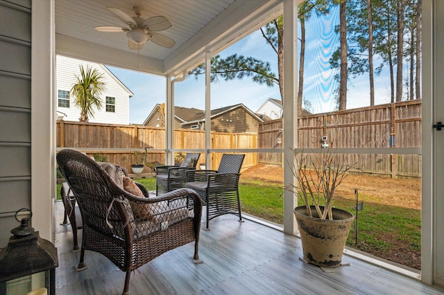 wooden terrace with ceiling fan and an outdoor hangout area