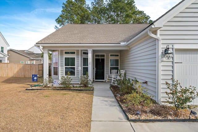 view of front of house featuring covered porch and a front lawn