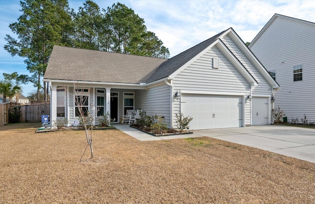 view of front facade featuring covered porch, a front yard, and a garage