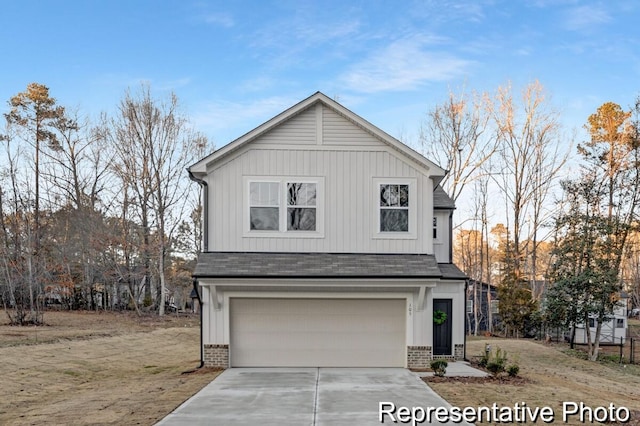 view of front of property featuring board and batten siding, concrete driveway, an attached garage, and a shingled roof