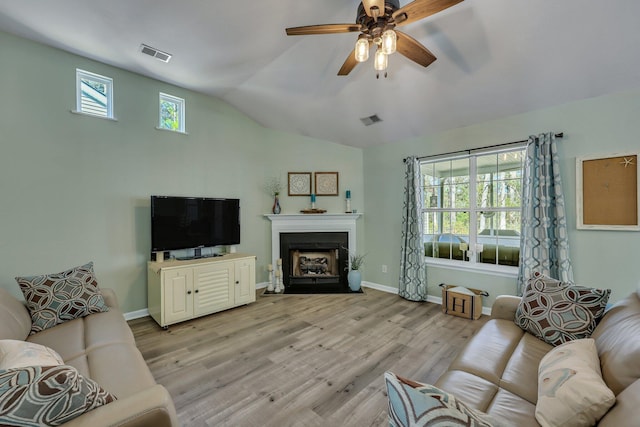 living room featuring vaulted ceiling, ceiling fan, and light hardwood / wood-style floors