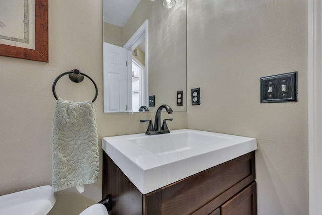 bathroom featuring toilet and vanity