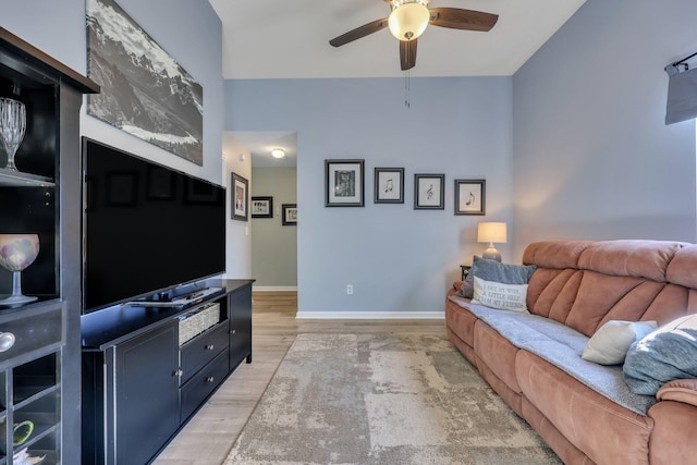 living room with ceiling fan and light hardwood / wood-style floors