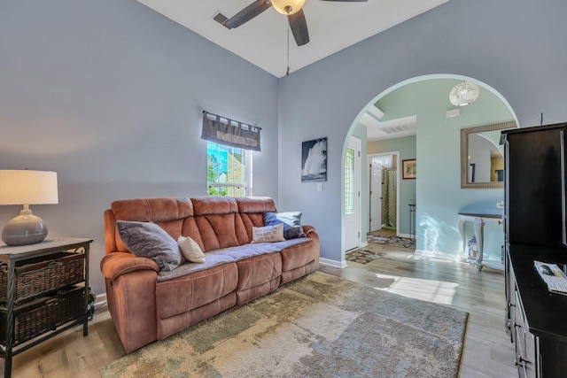 living room featuring vaulted ceiling, ceiling fan, and light hardwood / wood-style floors