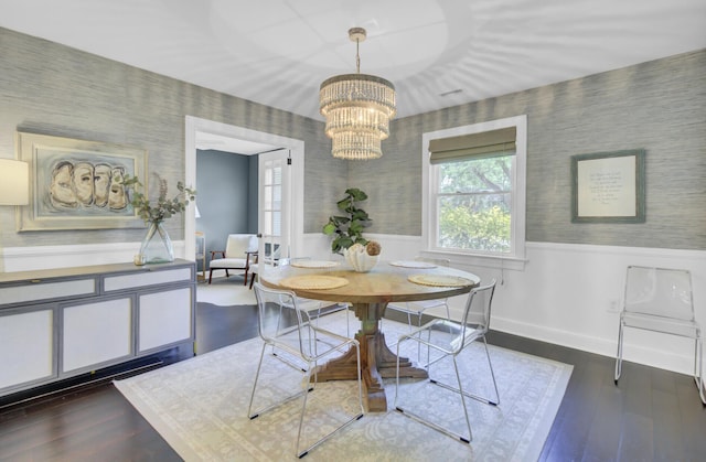 dining room featuring baseboards, a wainscoted wall, a chandelier, and wallpapered walls