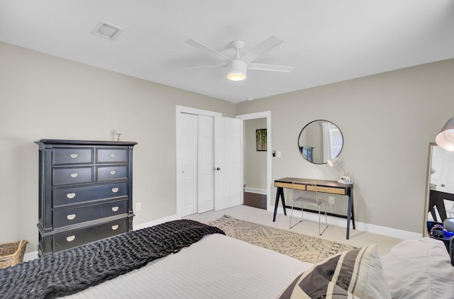 bedroom with baseboards, ceiling fan, a closet, and visible vents