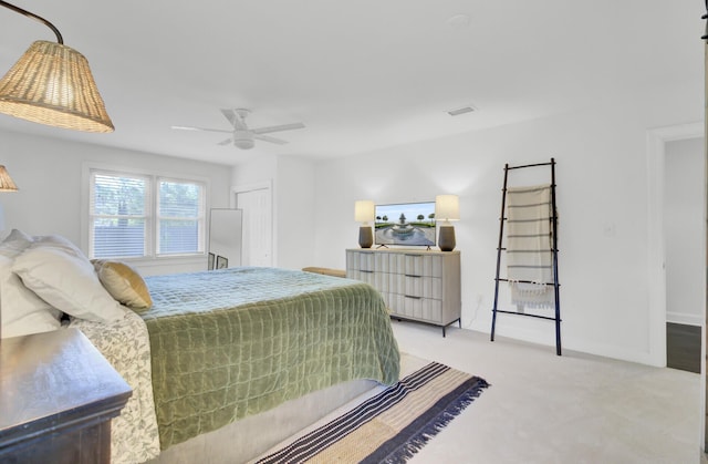 bedroom with light colored carpet, a ceiling fan, baseboards, and visible vents