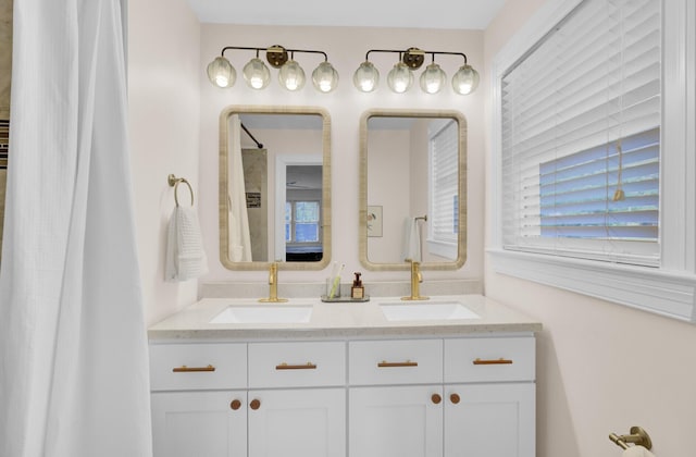 bathroom with a sink and double vanity