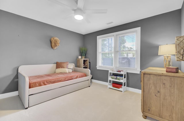 bedroom with baseboards, a ceiling fan, light colored carpet, and visible vents