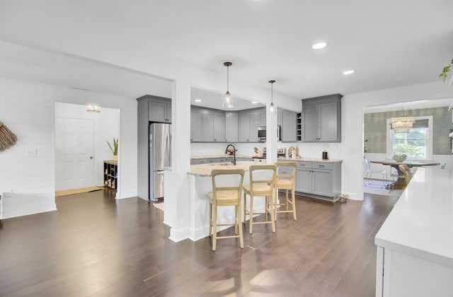 kitchen featuring gray cabinetry, appliances with stainless steel finishes, and recessed lighting