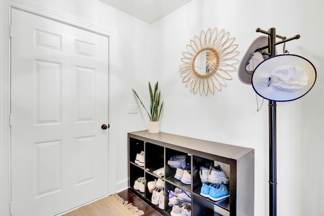 hallway featuring baseboards and wood finished floors