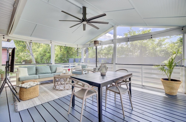 sunroom featuring an outdoor living space and a ceiling fan