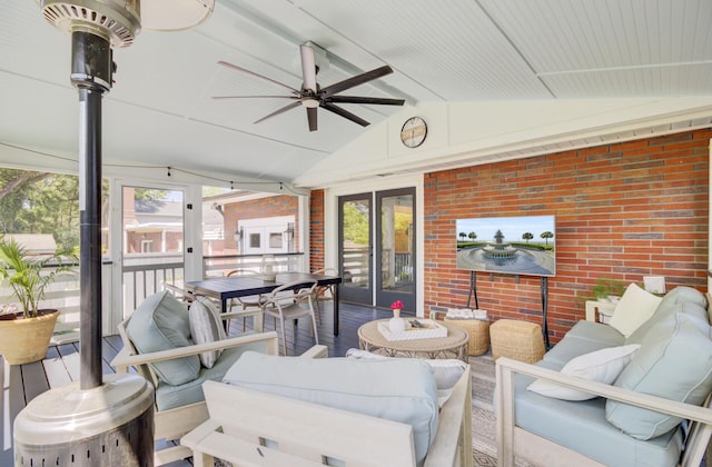 sunroom featuring beamed ceiling, a ceiling fan, and outdoor lounge area
