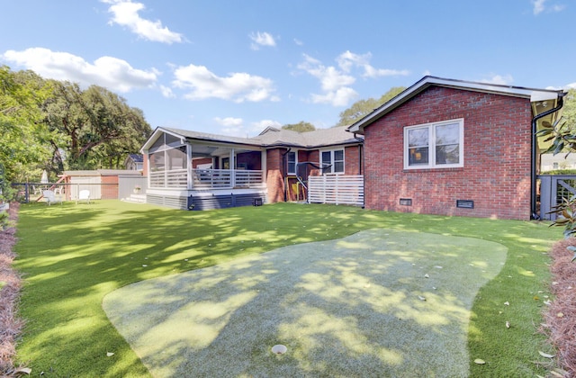 single story home with fence, a front lawn, brick siding, a sunroom, and crawl space