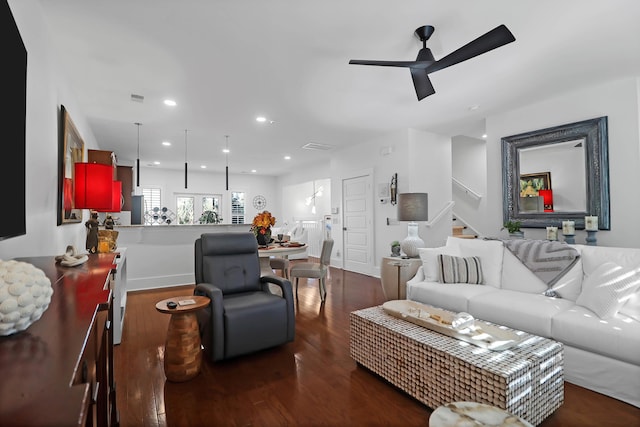 living room with dark hardwood / wood-style flooring and ceiling fan