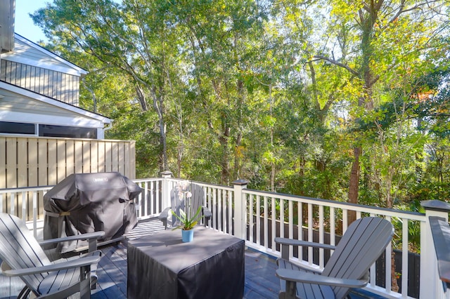 wooden deck featuring a grill