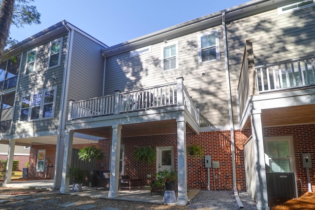 back of property with a balcony