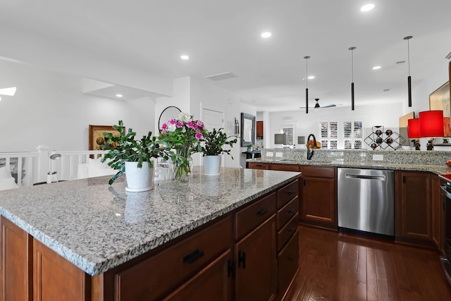 kitchen with pendant lighting, dishwasher, sink, ceiling fan, and light stone countertops