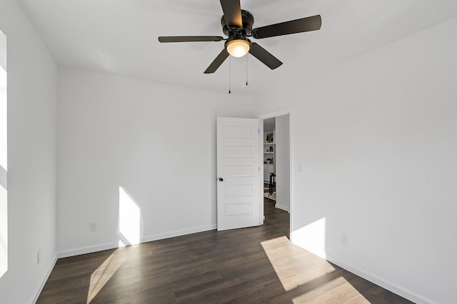 empty room featuring dark hardwood / wood-style floors and ceiling fan