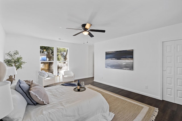 bedroom with dark hardwood / wood-style flooring, a closet, and ceiling fan