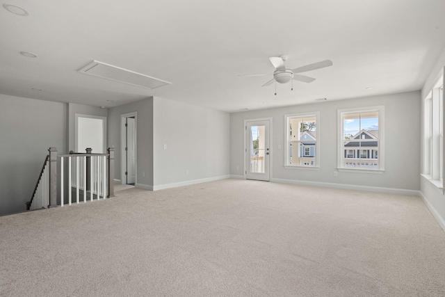 empty room with ceiling fan and light colored carpet