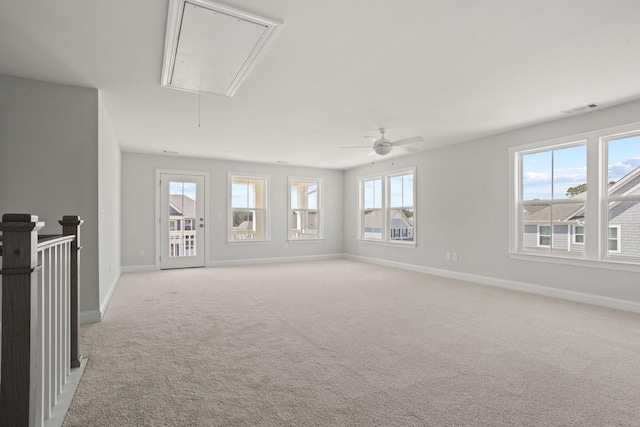 unfurnished living room with ceiling fan, light colored carpet, and a healthy amount of sunlight