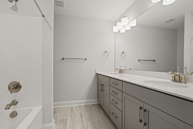 bathroom featuring vanity and shower / washtub combination