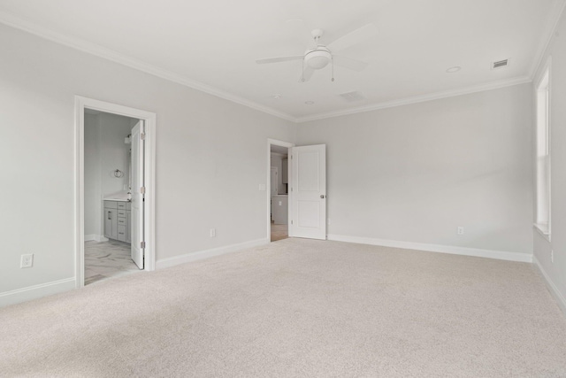 unfurnished bedroom with ensuite bathroom, light colored carpet, ceiling fan, and crown molding