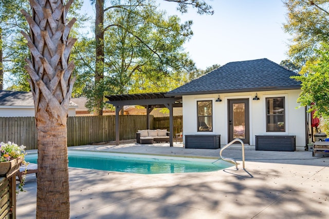 view of swimming pool featuring an outbuilding, an exterior structure, a patio area, fence, and a pergola