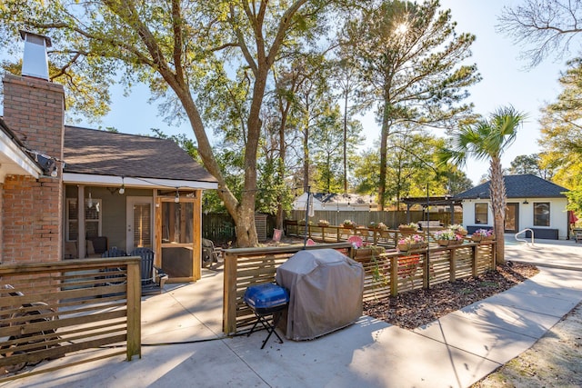 view of patio featuring area for grilling and fence