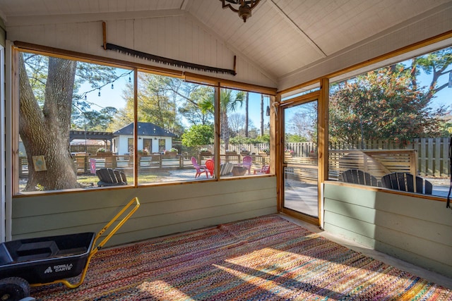 sunroom / solarium featuring lofted ceiling