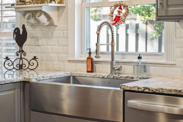 kitchen featuring a sink, a healthy amount of sunlight, backsplash, dishwasher, and open shelves