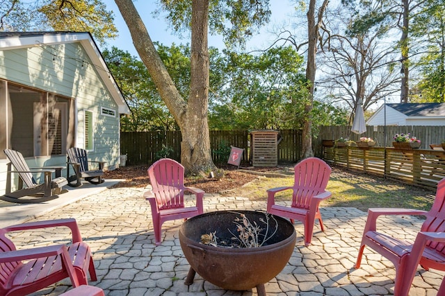 view of patio / terrace with a fenced backyard and a fire pit