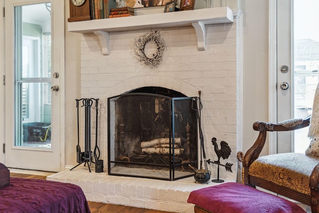 interior details with a fireplace and wood finished floors