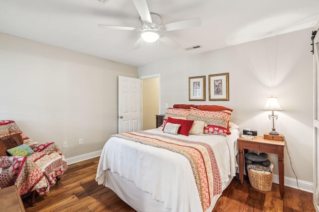 bedroom featuring ceiling fan, wood finished floors, visible vents, and baseboards