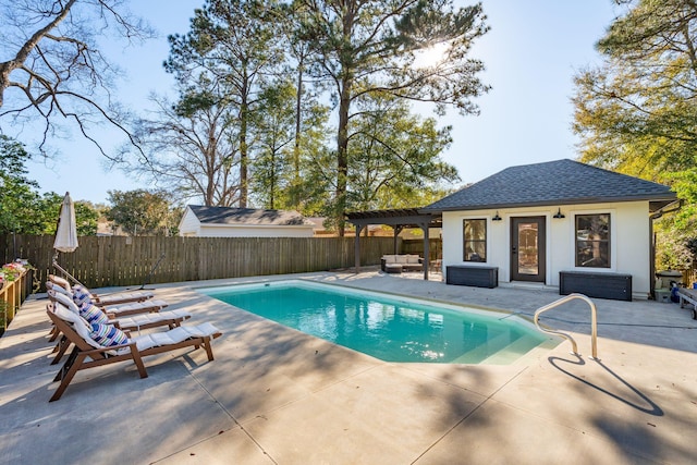 view of pool with a storage structure, a fenced backyard, a patio, and an outdoor structure