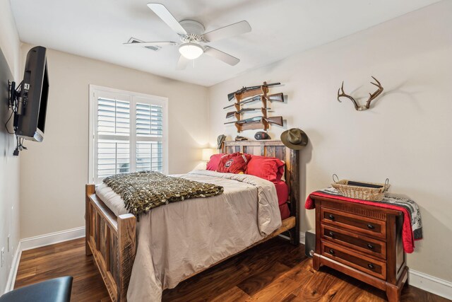 bedroom with dark wood-style floors, baseboards, and a ceiling fan