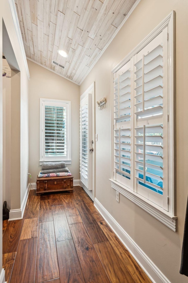 doorway to outside with baseboards, visible vents, wooden ceiling, hardwood / wood-style flooring, and vaulted ceiling