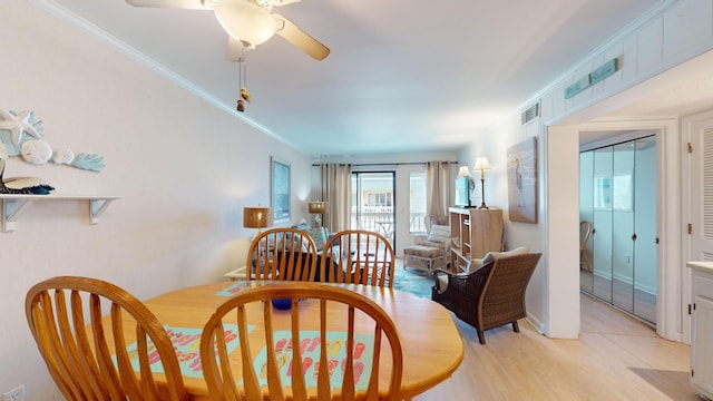 dining space featuring ceiling fan, light wood-type flooring, and ornamental molding