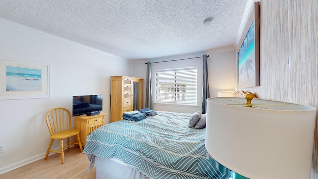 bedroom with a textured ceiling and hardwood / wood-style flooring