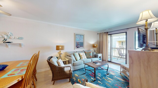 living room featuring hardwood / wood-style flooring and crown molding