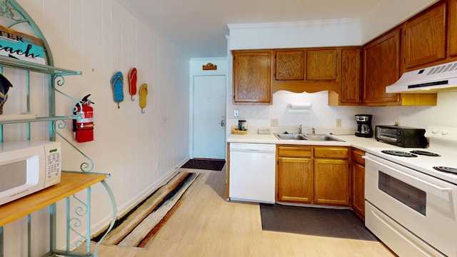 kitchen with crown molding, light hardwood / wood-style flooring, white appliances, and sink