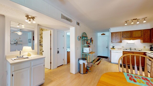 kitchen with ceiling fan, white cabinets, sink, white appliances, and light hardwood / wood-style floors