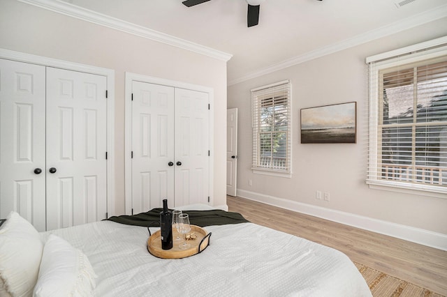 82 Ponsbury Rd, Mount Pleasant, SC 29464 - bedroom with multiple closets, wood finished floors, baseboards, ornamental molding, and ceiling fan